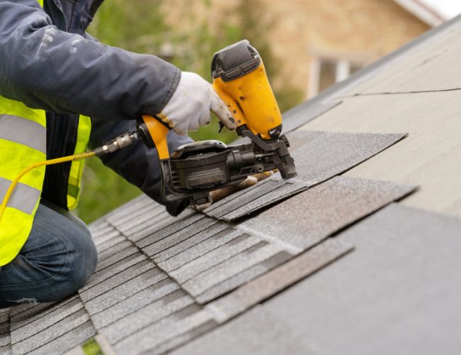 Roofer,Worker,In,Special,Protective,Work,Wear,And,Gloves,,Using